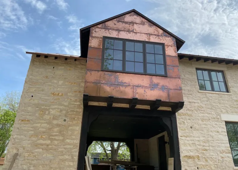 Copper metal panel facade on a stone building for Skylight Installation in Severna Park