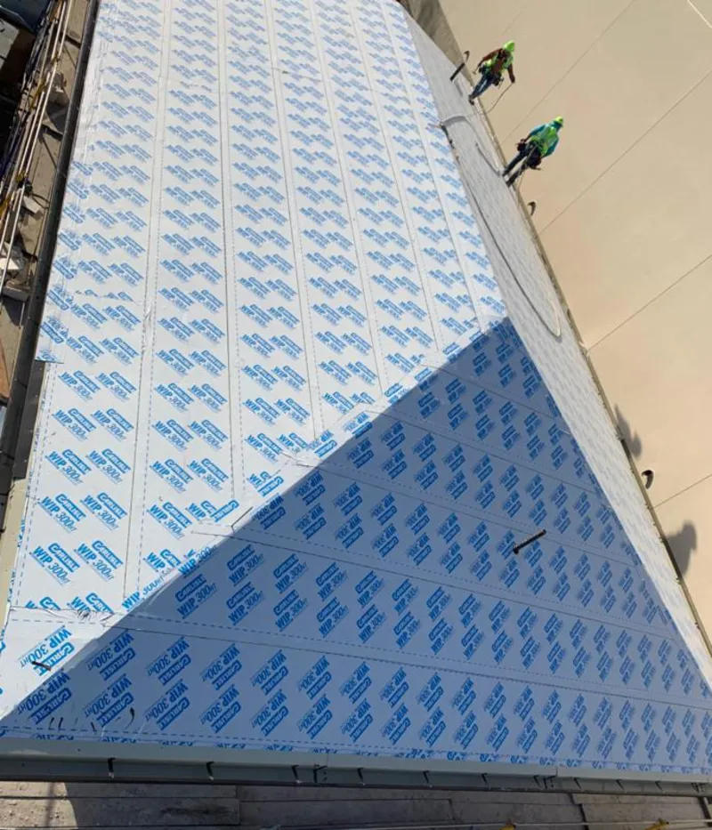 Professional roofers installing underlayment on a metal roof in Severna Park